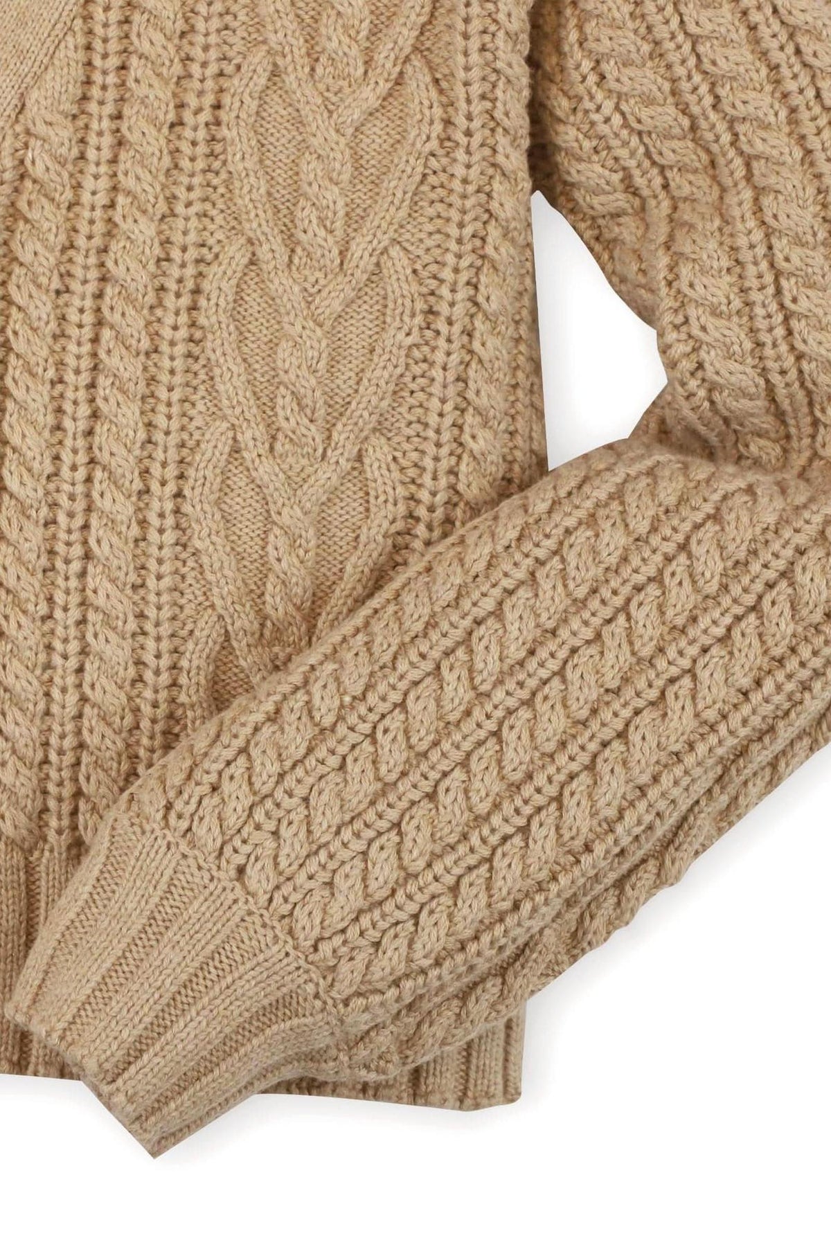 Close-up of a chunky cable cardigan in camel-colored organic cotton, featuring intricate knit patterns and a ribbed hem.