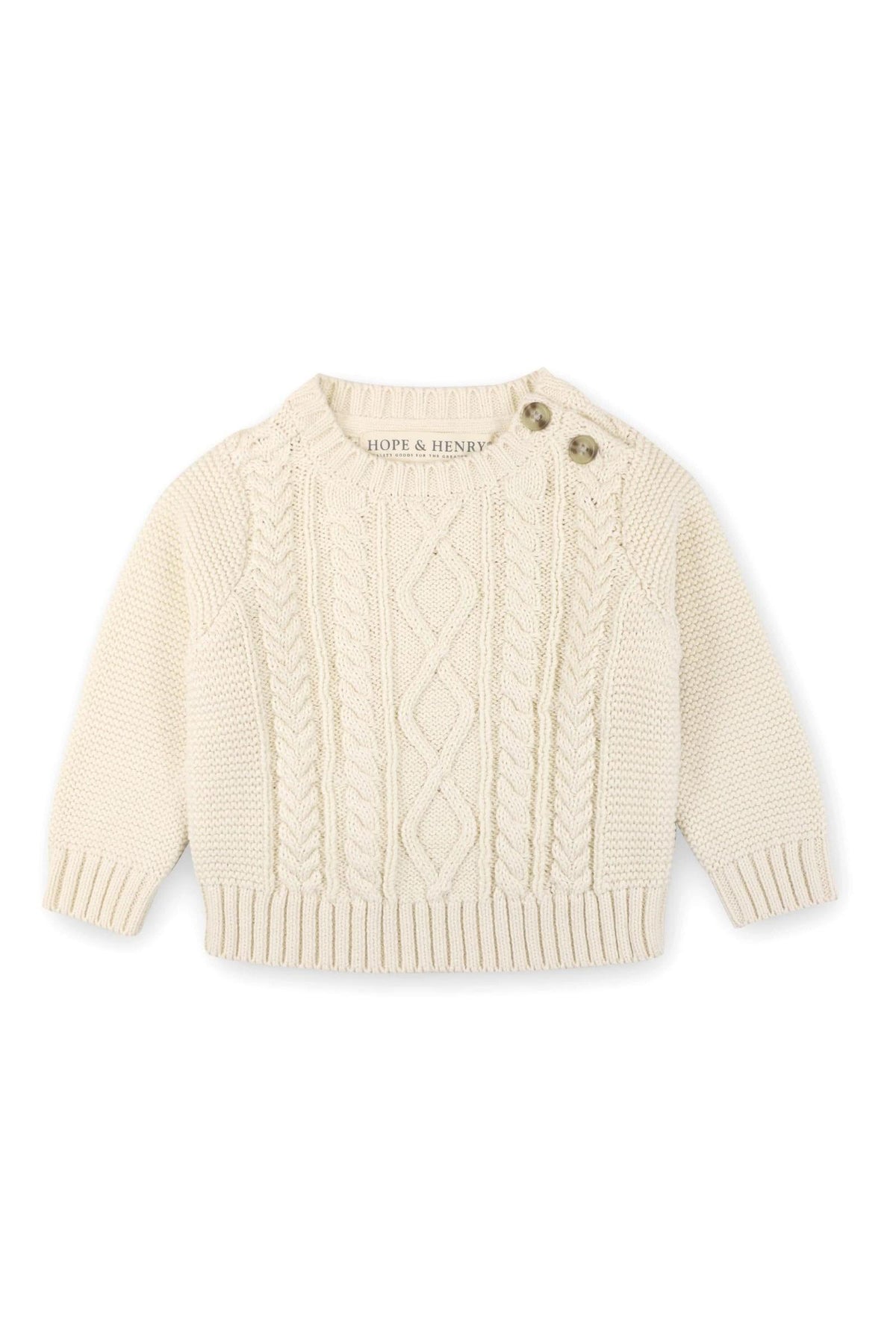 A cozy ivory cable knit sweater by Hope & Henry features faux horn shoulder buttons for easy dressing. Made from organic cotton, its perfect for babies aged 0-24 months.