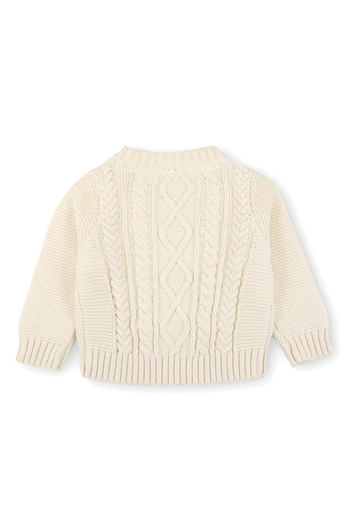 Ivory cable knit sweater featuring a round neckline and ribbed cuffs, made from organic cotton. Ideal for babies aged 0-24 months, this stylish piece offers comfort and warmth.