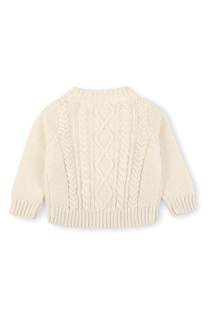 Ivory cable knit sweater featuring a round neckline and ribbed cuffs, made from organic cotton. Ideal for babies aged 0-24 months, this stylish piece offers comfort and warmth.