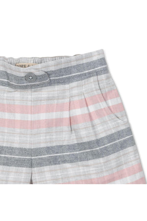 Close-up of Hope & Henry plaid shorts featuring soft organic cotton flannel in pastel pink, gray, and white stripes. The shorts showcase a faux button front and pleated design.