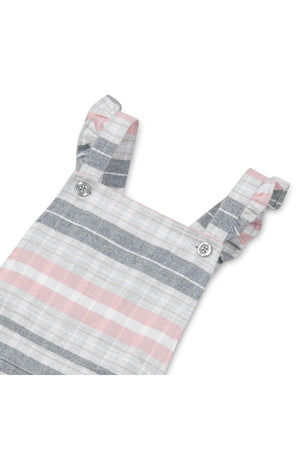 Gray and rose plaid overall skirt featuring ruffle straps and adjustable button closures. Made from organic cotton, this stylish piece is perfect for toddlers and kids.