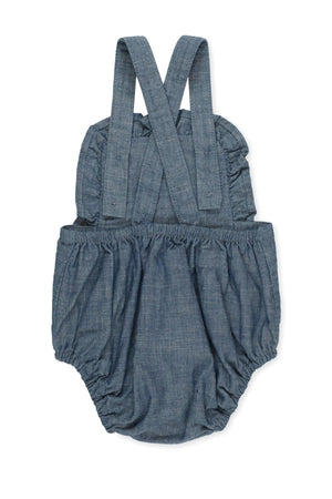 Blue chambray organic cotton ruffle sunsuit with adjustable straps and bubble silhouette, perfect for baby girls in warm weather.