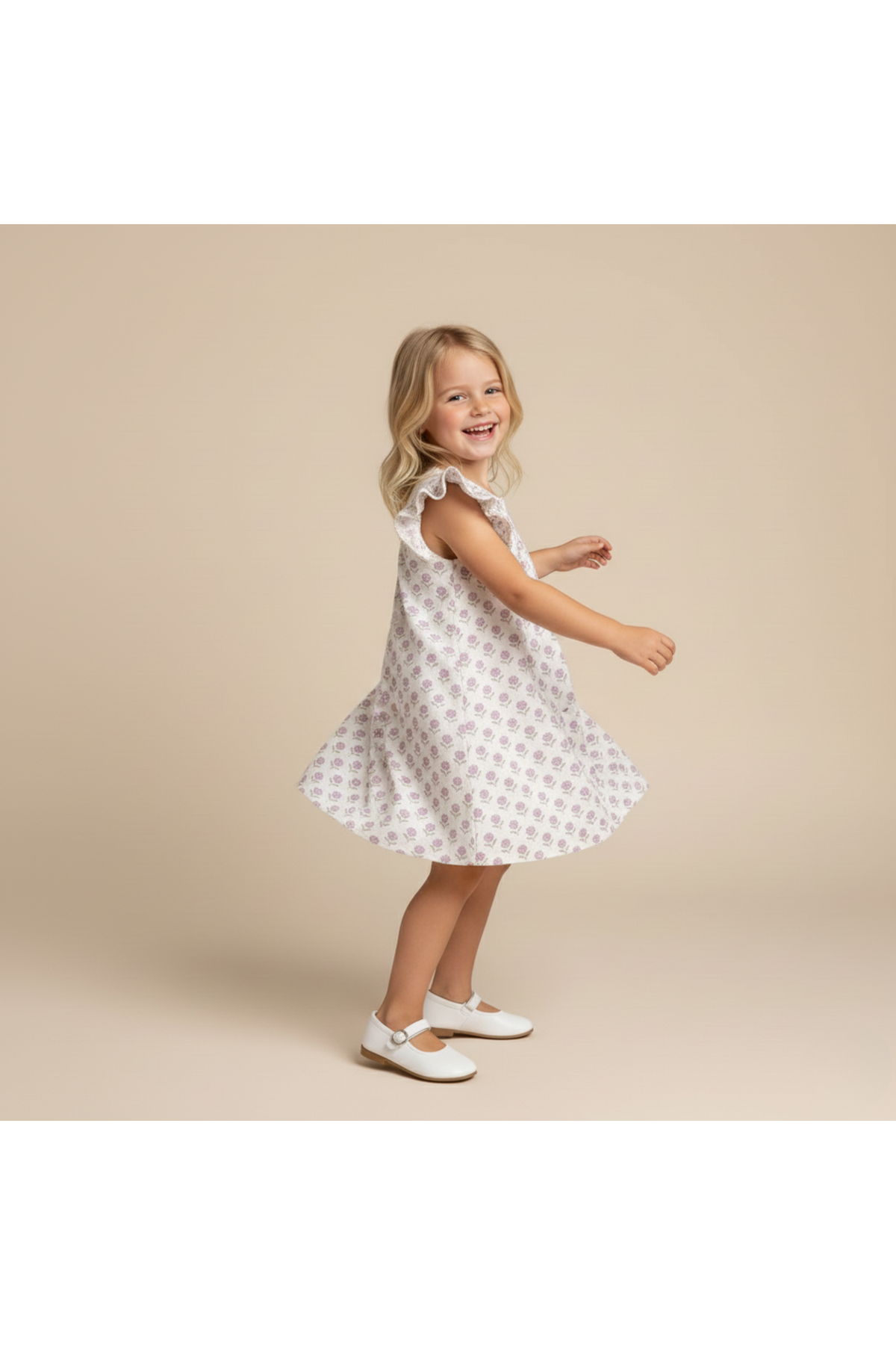 A young girl twirls in a short sleeve, lavender dress featuring a playful floral pattern. The dress is made from soft, breathable fabric, perfect for warm days and active play.