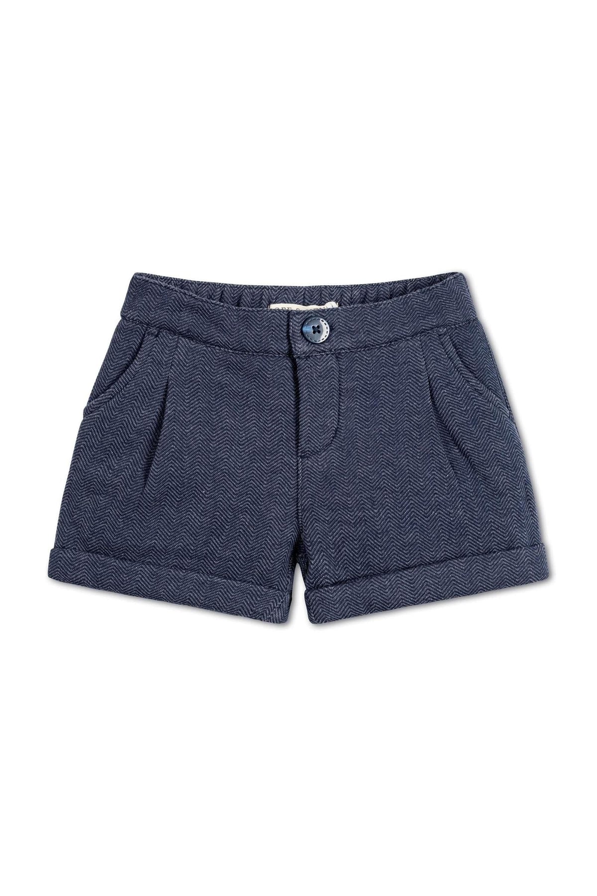 Navy blue dress shorts featuring a herringbone pattern, faux zip opening, and cuffed hem, made from organic cotton blend.