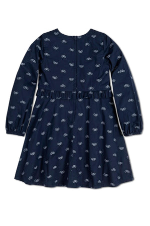 Navy dress featuring a bicycle print, long sleeves, and a ruffle waist detail, made from soft organic cotton.