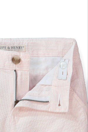 Close-up of Hope & Henry pink organic cotton seersucker shorts, featuring a zipper and button closure, showcasing the classic striped.