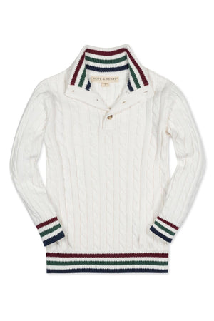 A white organic cotton mock neck cable sweater for baby boys features classic cable patterns, faux horn button closures, and striped trim at the cuffs and hem.