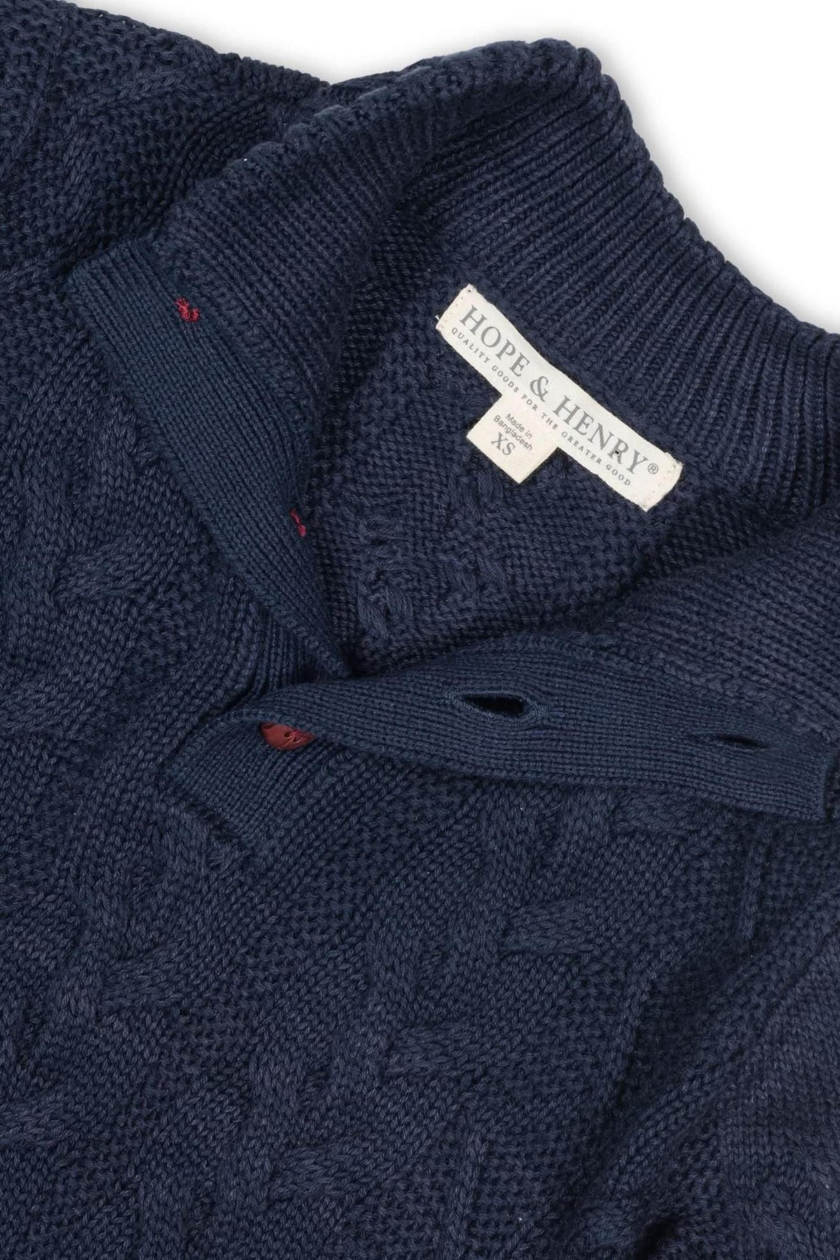 Close-up of a navy blue mock neck cable sweater by Hope & Henry, featuring a rib knit collar and faux.