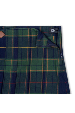 Close-up of a navy plaid skirt featuring green and yellow lines, showcasing pleats and a faux leather buckle detail.