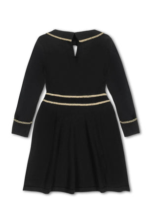 Back view of a black organic cotton sweater dress for girls, featuring gold tipping along the collar, cuffs, and waist, with a keyhole button closure at the back.