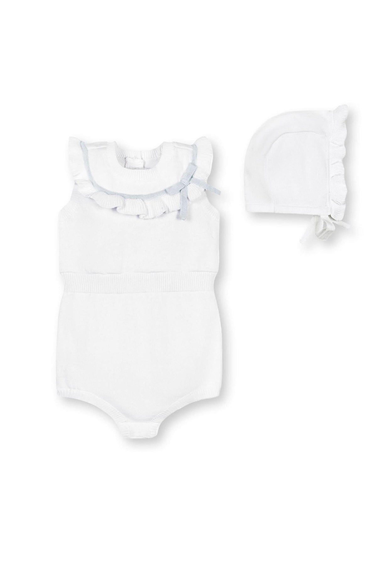 A white organic cotton romper features a ruffle collar with a blue bow, accompanied by a matching ruffle-edge bonnet.
