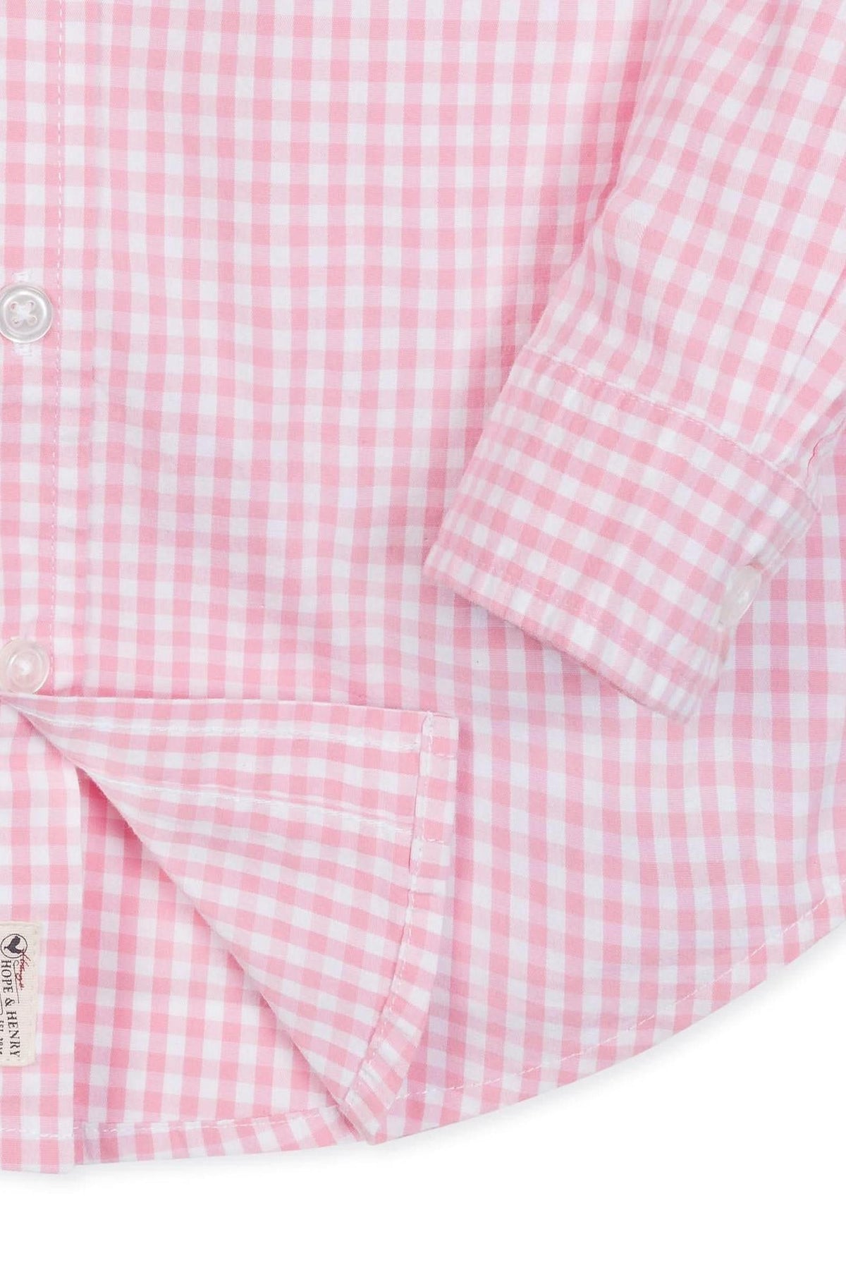 Close-up of a pink gingham check button-down shirt made from organic cotton, featuring a classic collar and cuff details, ideal for boys sizes 2T to 18/20. Soft and breathable fabric.