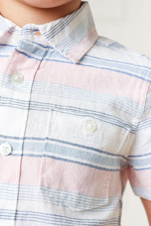 Close-up of a short-sleeve button-down shirt for boys featuring a pink and blue striped pattern. The shirt is made from lightweight linen, ideal for warm weather comfort.