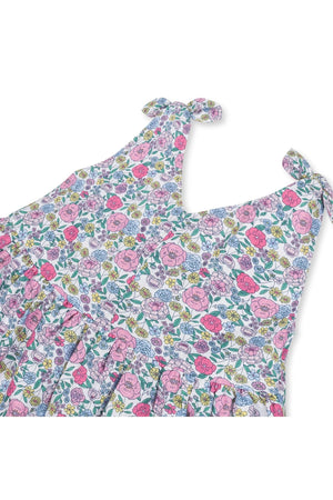 The image showcases a floral linen dress featuring bow shoulder straps in vibrant pink and purple hues. This sustainable dress is ideal for toddlers and kids, perfect for summer wear.