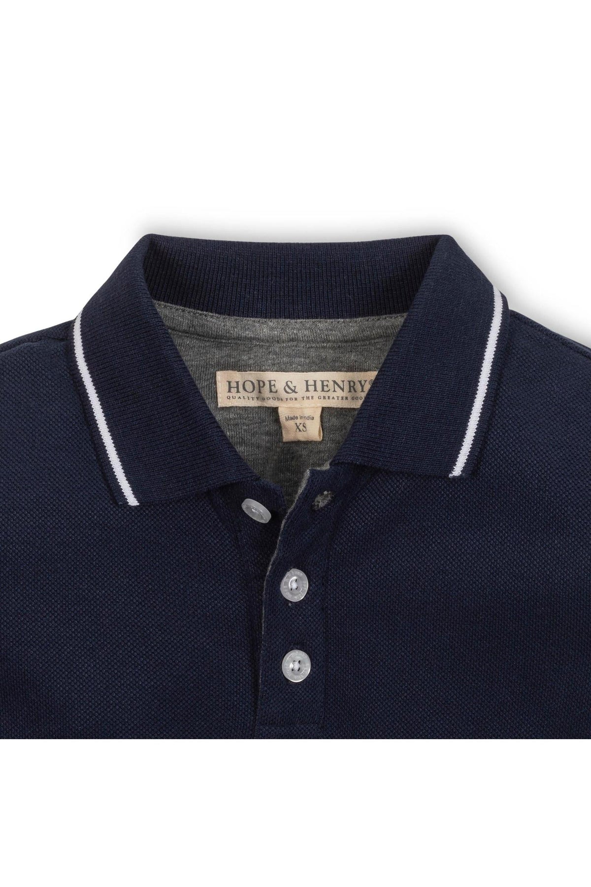 Close-up view of a navy blue Hope & Henry organic cotton polo featuring a pointed collar with white tipping and a front button placket.