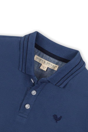 Navy blue organic cotton piqué polo shirt by Hope & Henry featuring a flat knit collar and three buttons.