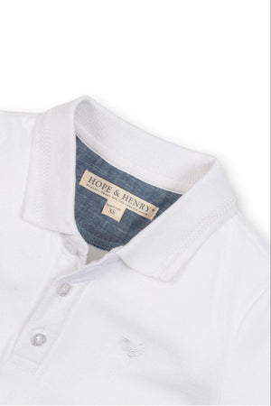 White organic cotton polo shirt from Hope & Henry featuring a flat-knit collar and a button placket.