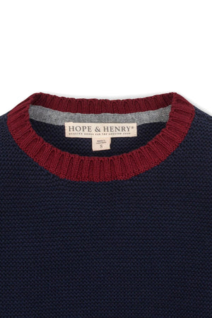 Close-up of a navy and gray crewneck sweater by Hope & Henry, featuring a textured knit and a maroon ribbed.