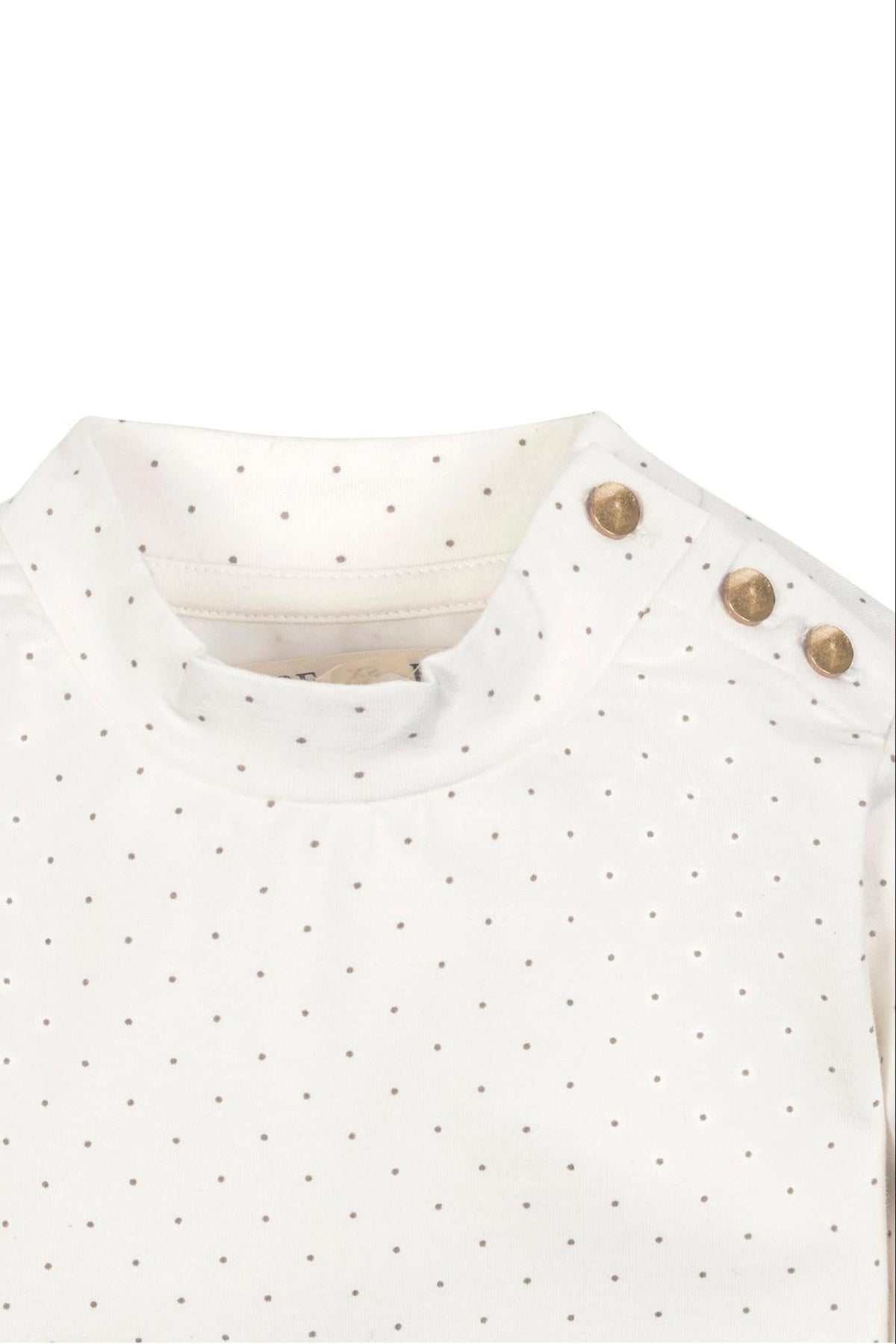 Close-up of a soft white organic cotton mock neck knit top featuring a dotted pattern and gold shoulder buttons, designed for toddlers and kids by Hope & Henry.
