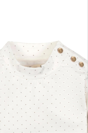 Close-up of a soft white organic cotton mock neck knit top featuring a dotted pattern and gold shoulder buttons, designed for toddlers and kids by Hope & Henry.