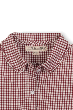 Close-up of a Hope & Henry organic cotton shirt featuring a red and white gingham pattern, with a Peter Pan.