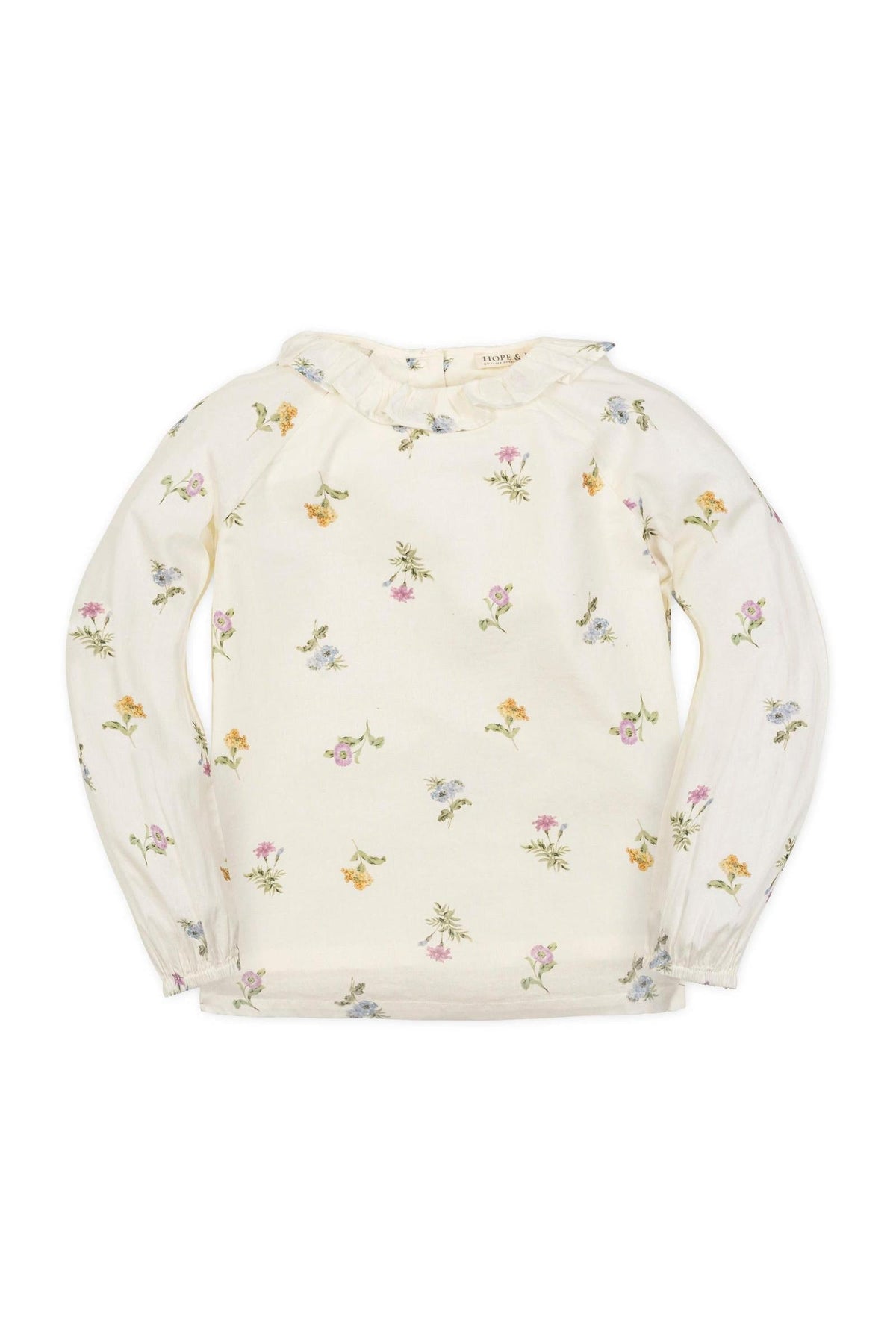 Ivory long-sleeve top with a ruffle collar, featuring a delicate floral print in soft pastel colors. Made from organic cotton.
