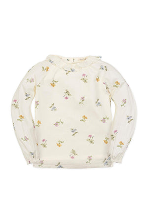 Ivory long-sleeve top with a ruffle collar, featuring a delicate floral print in soft pastel colors. Made from organic cotton.