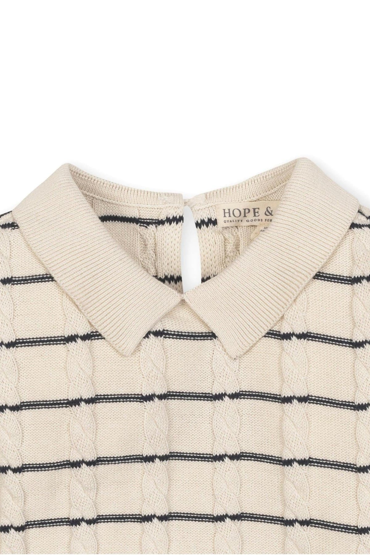 Close-up of an ivory cable knit sweater dress featuring a Peter Pan collar and navy Breton stripes, labeled Hope &.