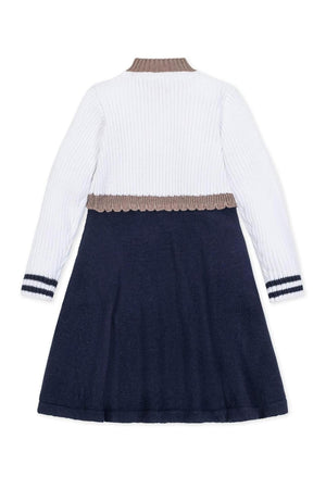 Back view of a Hope & Henry organic cotton sweater dress for girls, featuring a white ribbed upper and a navy skirt with contrast stripes, designed for toddlers and kids.