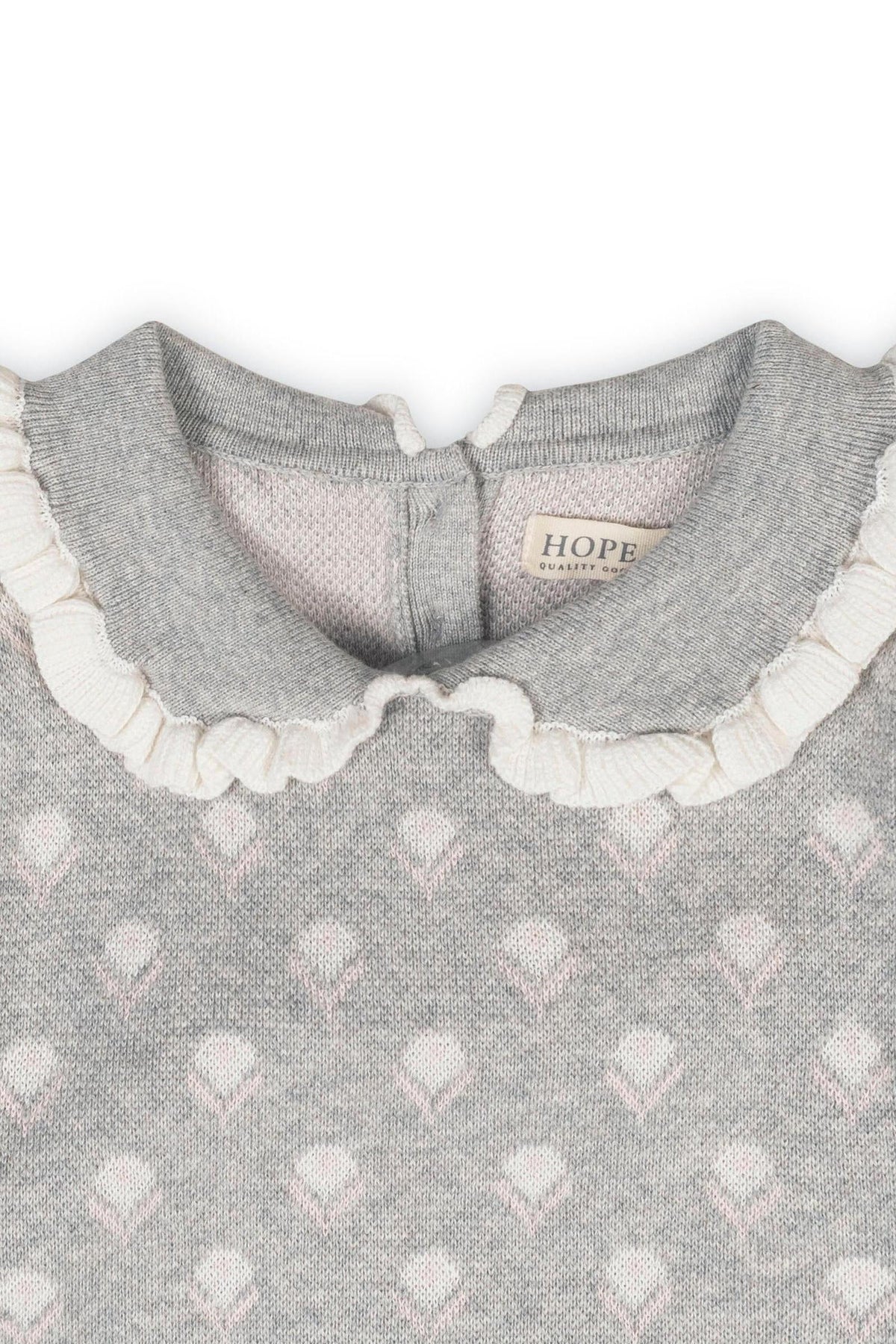 Close-up of a gray sweater featuring a Peter Pan collar with ruffle edges and floral intarsia design, labeled HOPE.
