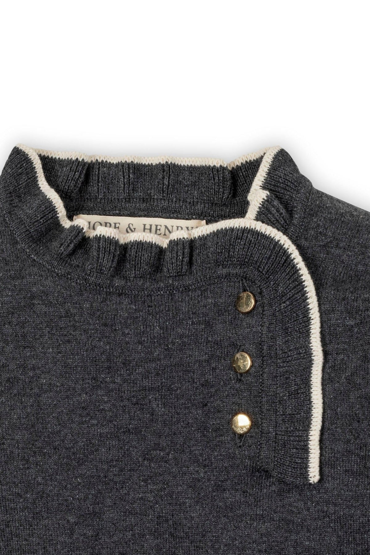 Close-up of a charcoal gray sweater dress featuring a ruffled collar and gold buttons, made from organic cotton.
