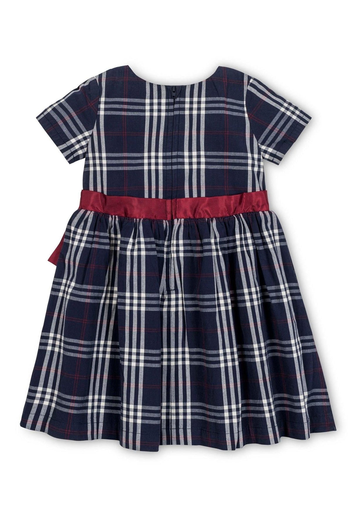 Navy plaid dress with short sleeves, featuring a smocked bodice and a red satin waistband, made from organic cotton.