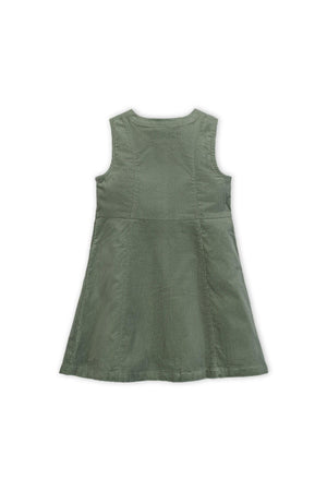 Back view of a sage green corduroy jumper dress, showcasing a flared A-line silhouette and shoulder straps.