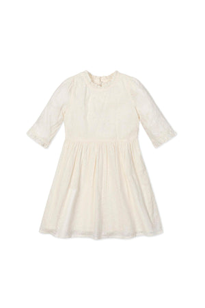 Ivory toddler dress with ruffle edges and eyelet design, featuring elbow-length sleeves and organic cotton fabric.