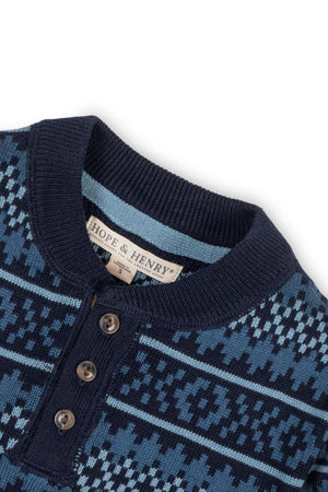 Close-up of a Hope & Henry navy sweater featuring a henley neckline, faux suede elbow patches, and a Fair Isle.