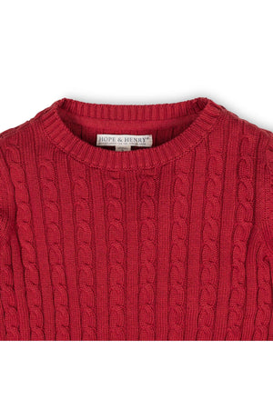 Close-up of a red cable knit crewneck sweater by Hope & Henry, featuring a ribbed neckline and soft organic cotton.