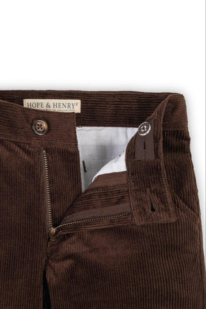Close-up of Hope & Henry chocolate brown organic cotton corduroy pants, showcasing the zip fly, button closure, and textured fabric.