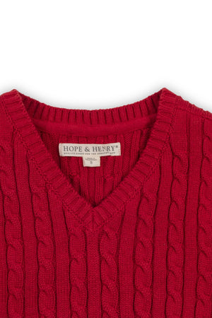 A close-up of a vibrant red cable-knit sweater vest by Hope & Henry, showcasing a classic v-neck design.