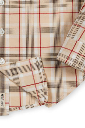 Close-up of a beige plaid shirt featuring red and black lines, showcasing organic cotton fabric and a button-down design.
