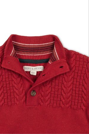 Close-up of a red mock neck sweater featuring a textured knit pattern and a button placket, labeled Hope & Henry.