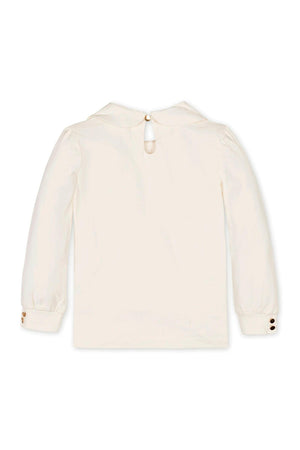 Back view of an ivory long-sleeve knit top featuring a Peter Pan collar and a keyhole neck closure.