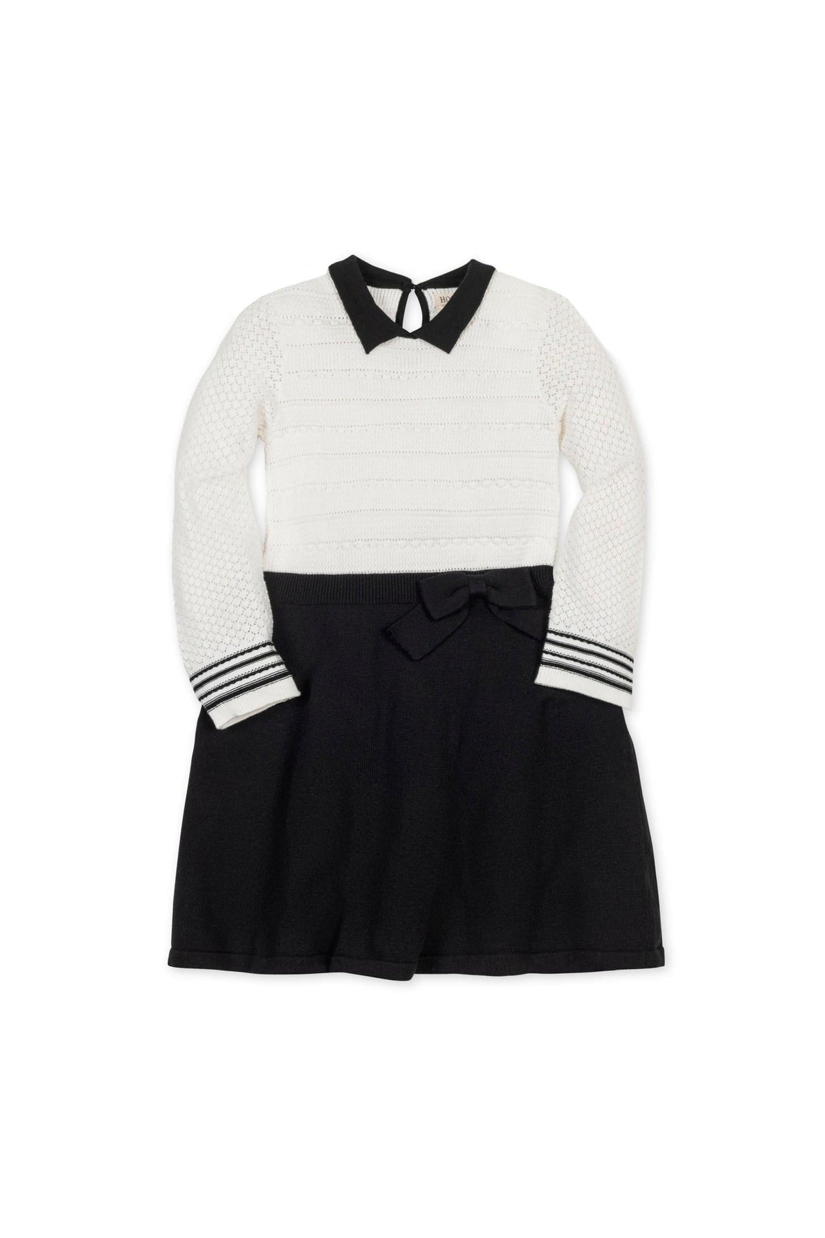 A white and black sweater dress featuring a Peter Pan collar, textured bodice, and a bow at the waist. Made from soft organic cotton, suitable for toddlers and kids.