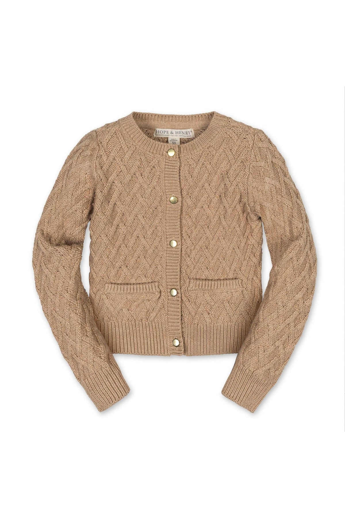 A soft, camel-colored cardigan made of organic cotton features a herringbone cable knit design, gold shank buttons, and two front pockets, ideal for toddlers and kids.