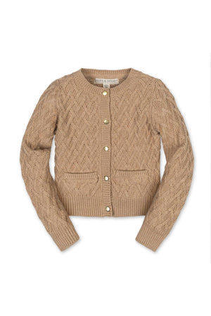 A soft, camel-colored cardigan made of organic cotton features a herringbone cable knit design, gold shank buttons, and two front pockets, ideal for toddlers and kids.
