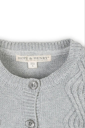 Close-up of a light gray Hope & Henry cardigan featuring a cable knit design and button closure, made of organic.