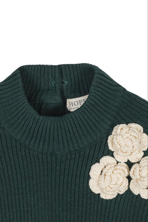 Dark green organic cotton sweater featuring a mock neck and decorative cream-colored rosettes, ideal for toddlers and kids.