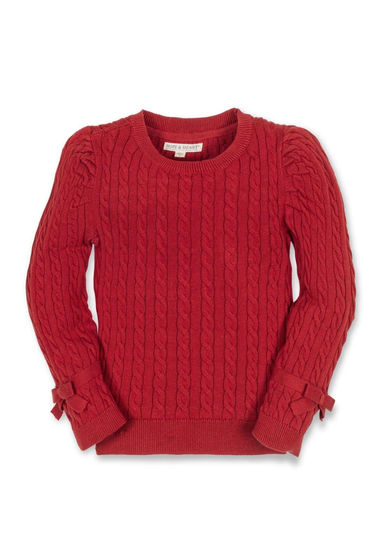 A red cable knit sweater for baby girls featuring puff sleeves and bow details at the cuffs, made from organic.