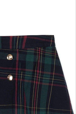 Close-up of a navy and green plaid skirt featuring decorative gold double buttons. Made from soft, GOTS-certified organic cotton, this classic design is perfect for girls everyday wear.