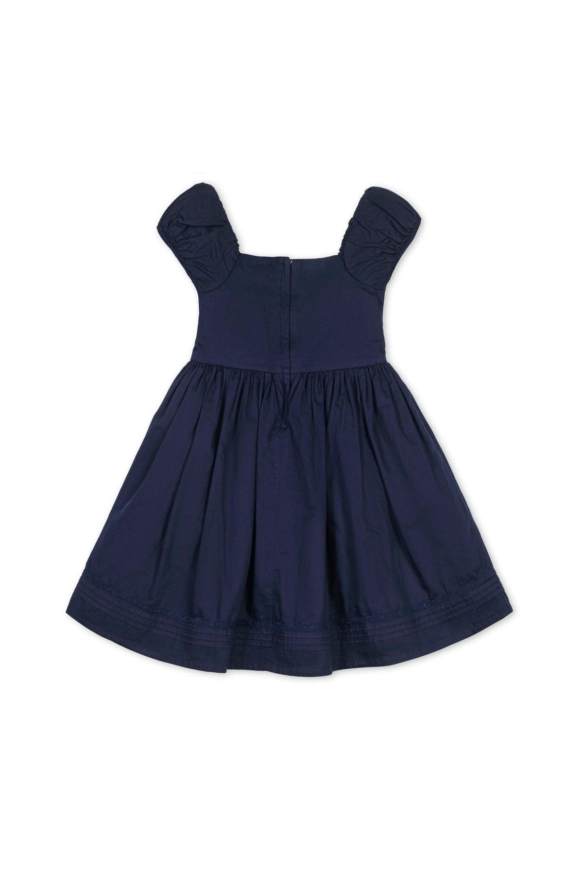 Navy organic cotton dress with puff sleeves and pintuck bodice, featuring a full skirt and delicate embroidered hem.